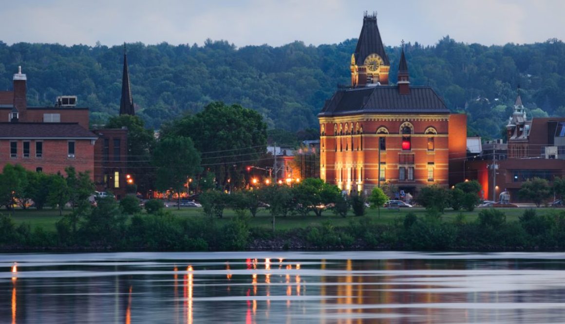 City hall reflected in the Saint John River in downtown Fredericton, New Brunswick, Canada